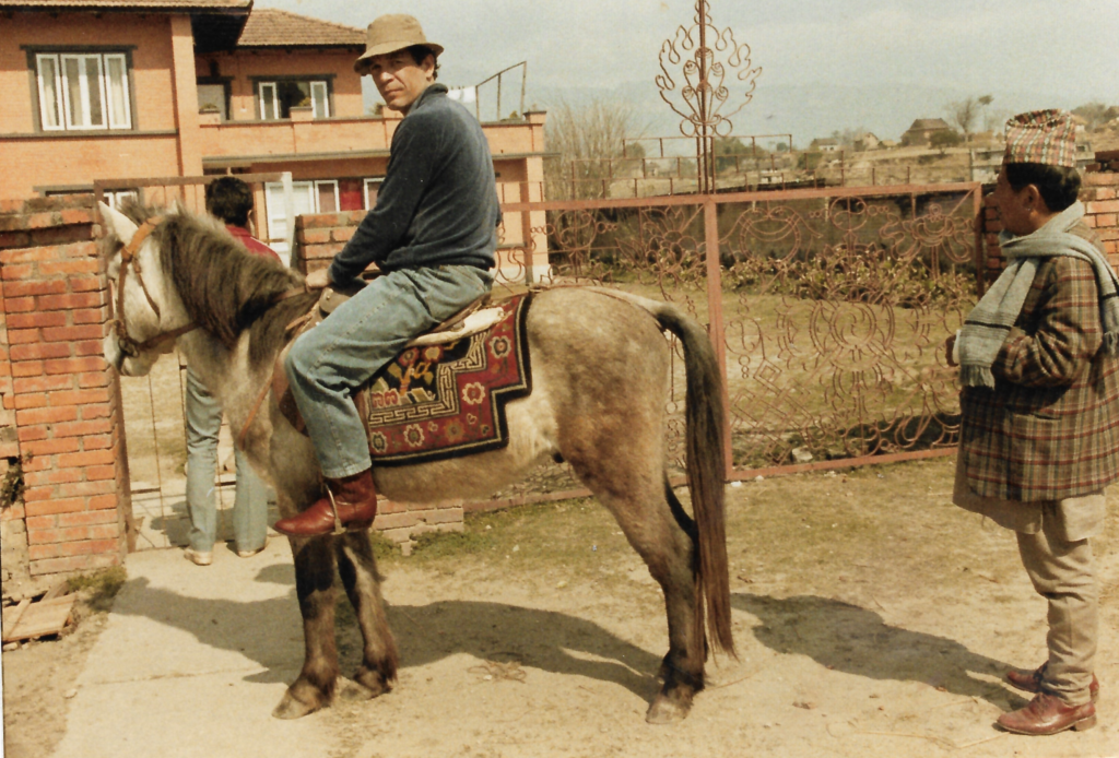 Joe Pietri, the legendary 1960s drug smuggler and cannabis seed collector, riding a horse in a rustic setting, symbolizing his landrace seed expeditions.